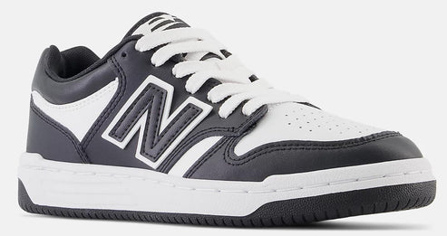 A low-top black and white New Balance sneaker with a large 'N' logo, white laces, and a white midsole.