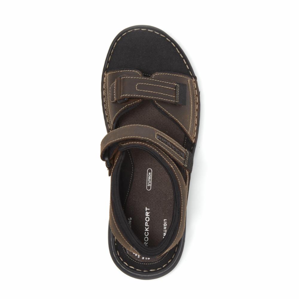 Overhead view of brown sandal with two hook-and-loop fasteners.