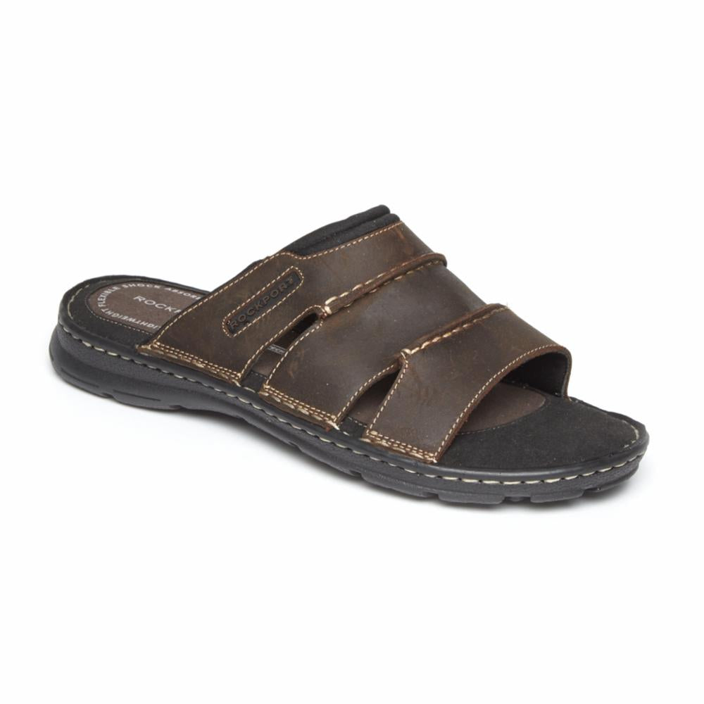 Brown leather slide sandal with black sole and white stitching