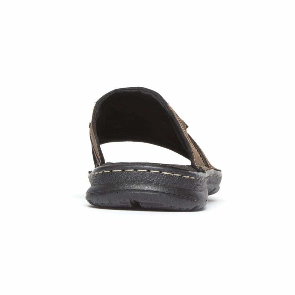Rear view of a brown slide sandal with dark sole.