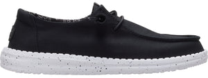 A black loafer-style shoe with a white sole speckled with black.
