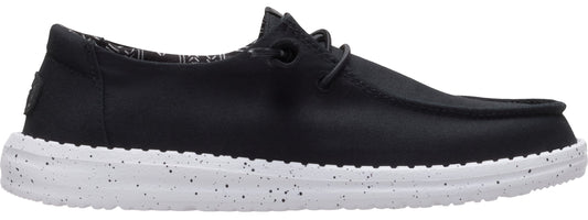 A black loafer-style shoe with a white sole speckled with black.