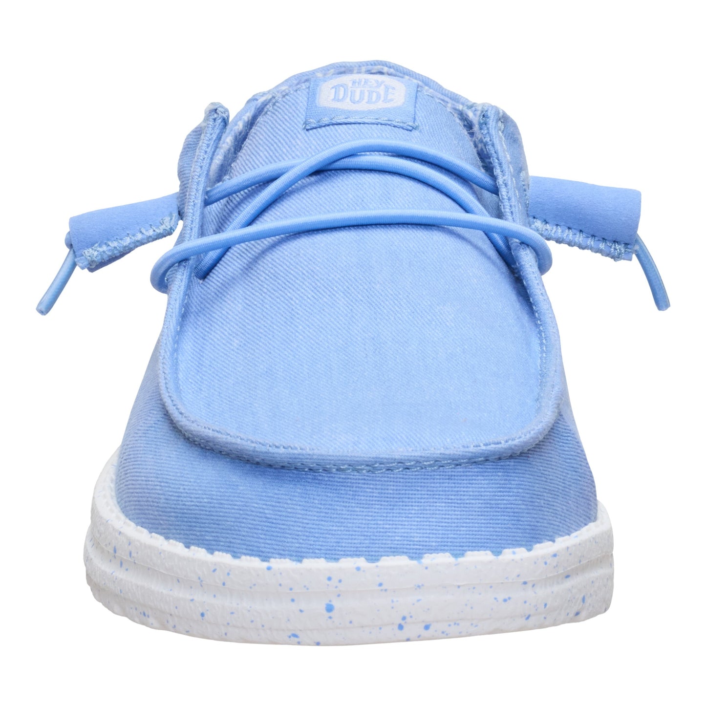 Light blue casual slip-on shoe with white sole and light blue laces, tag at the top of the shoe reads "DUDE".