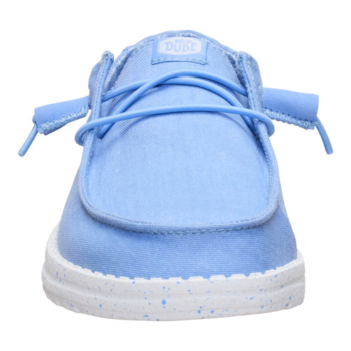 Light blue casual slip-on shoe with white sole and light blue laces, tag at the top of the shoe reads "DUDE".