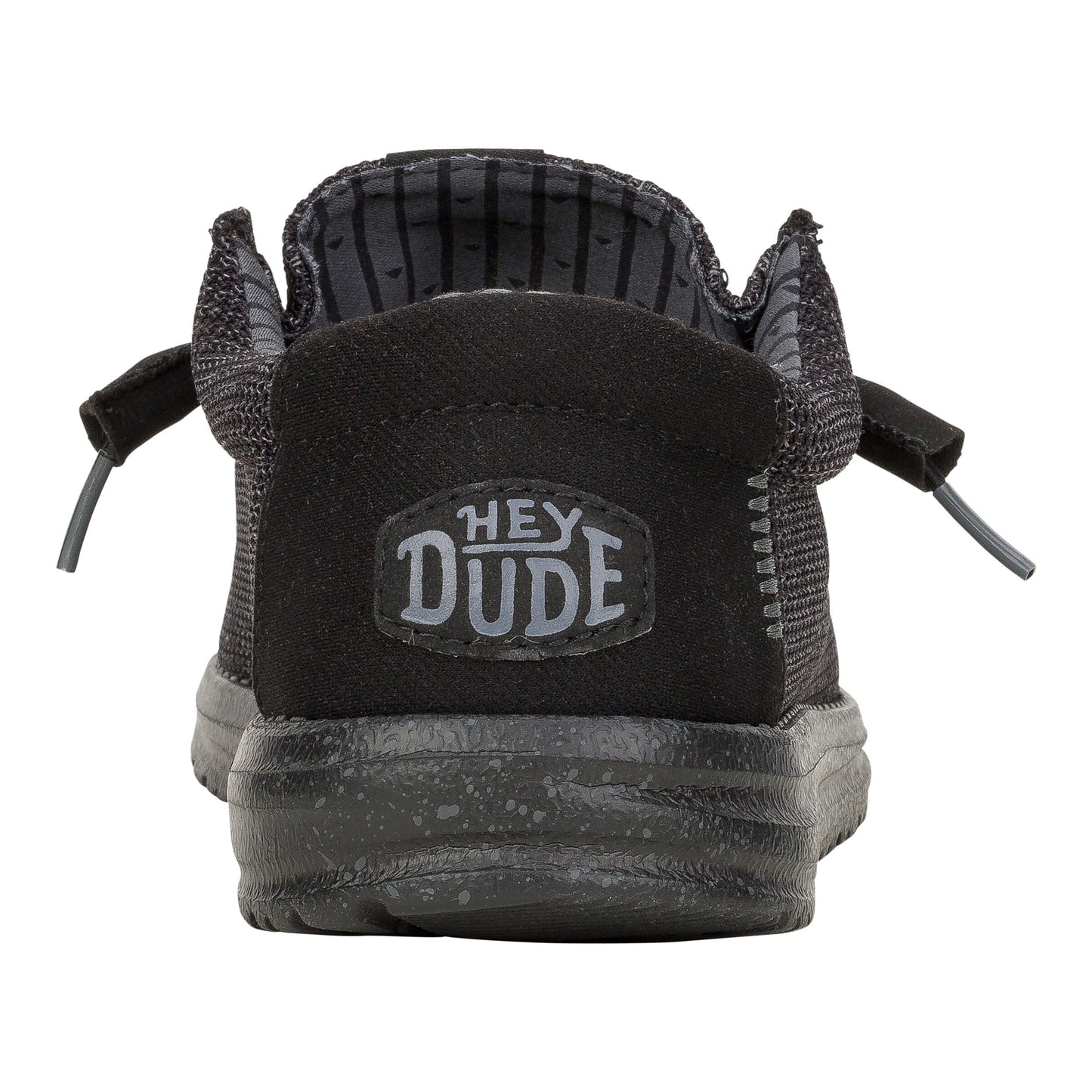 Back view of a black slip-on shoe with visible "HEY DUDE" logo on the heel.