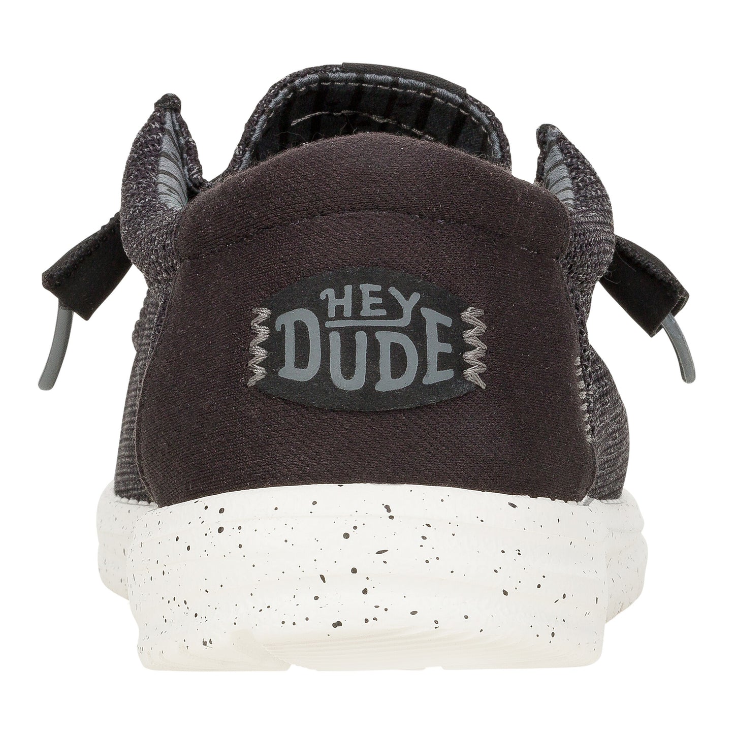 Back view of a slip-on shoe with a textured upper, gray heel with "HEY DUDE" logo, and a speckled white sole.