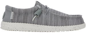 Gray slip-on shoe with white sole and decorative laces.