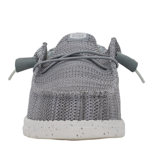 Back of a gray knit shoe with white speckled sole and tied gray laces.