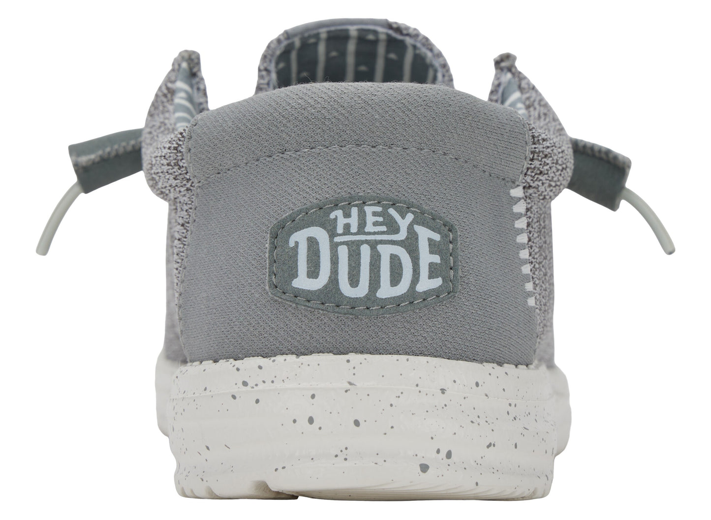 Back view of gray slip-on shoe with "HEY DUDE" emblem and white speckled sole.