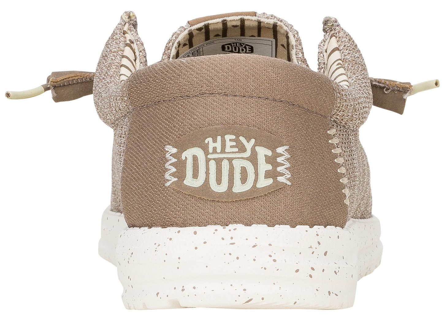 Rear view of a light brown Hey Dude slip-on shoe with a speckled white sole, featuring the HEY DUDE logo embroidered on a beige patch on the heel.