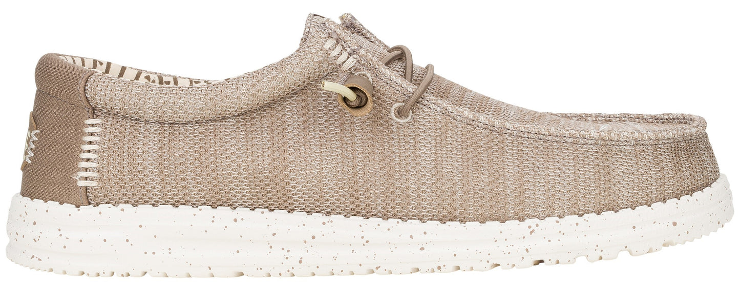 Slip-on shoe with a textured beige upper and a white sole.
