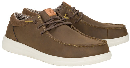 A pair of brown leather-style casual lace-up shoes with a white rubber sole, featuring a tan tongue patch and patterned lining on a plain white background.