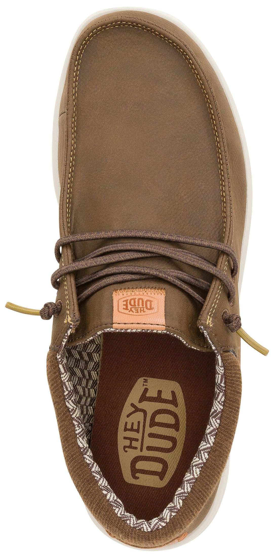 A top-down view of a brown casual slip-on shoe with elastic laces, featuring a patterned interior lining and a visible HEY DUDE logo on the footbed.