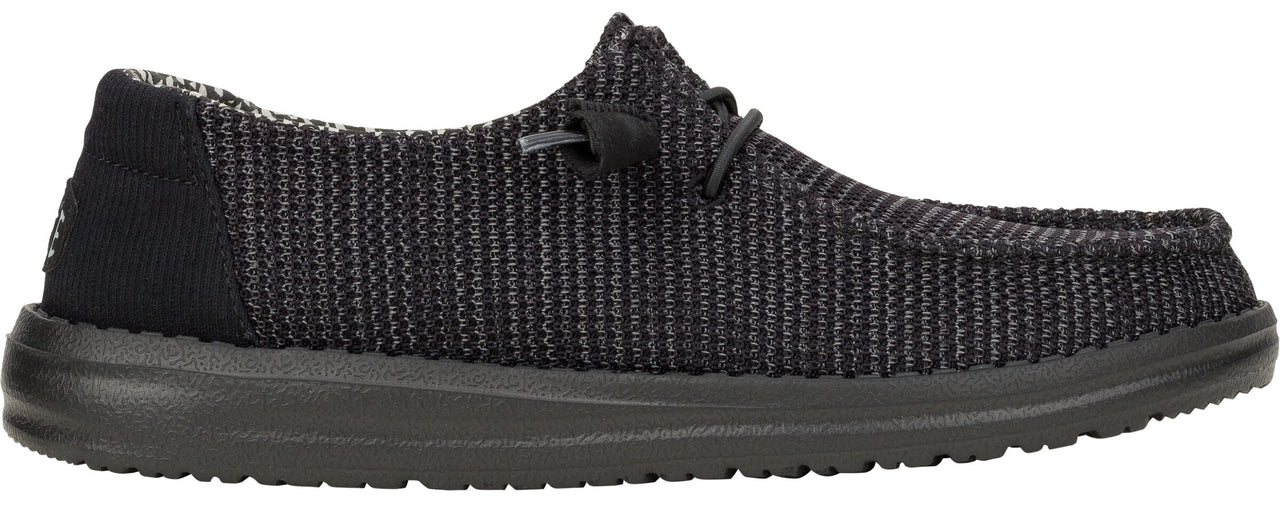 Black slip-on shoe with knitted upper and black sole.