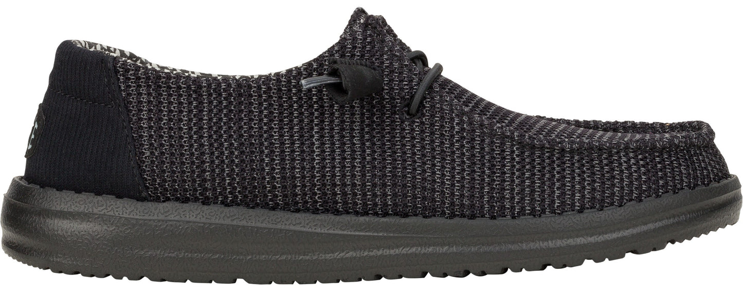 Black slip-on shoe with knitted upper and black sole.