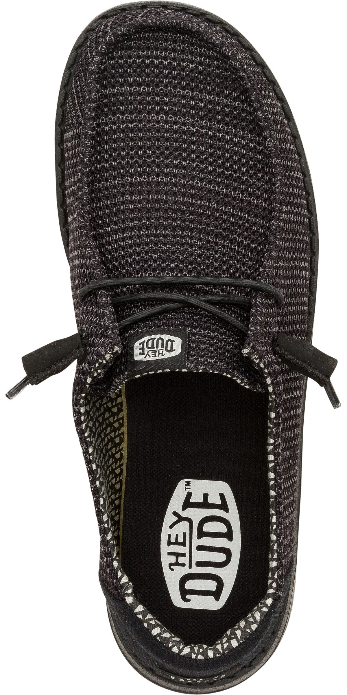 A top down view of a black slip-on shoe with visible laces and a white "HEY DUDE" logo on the inner sole.