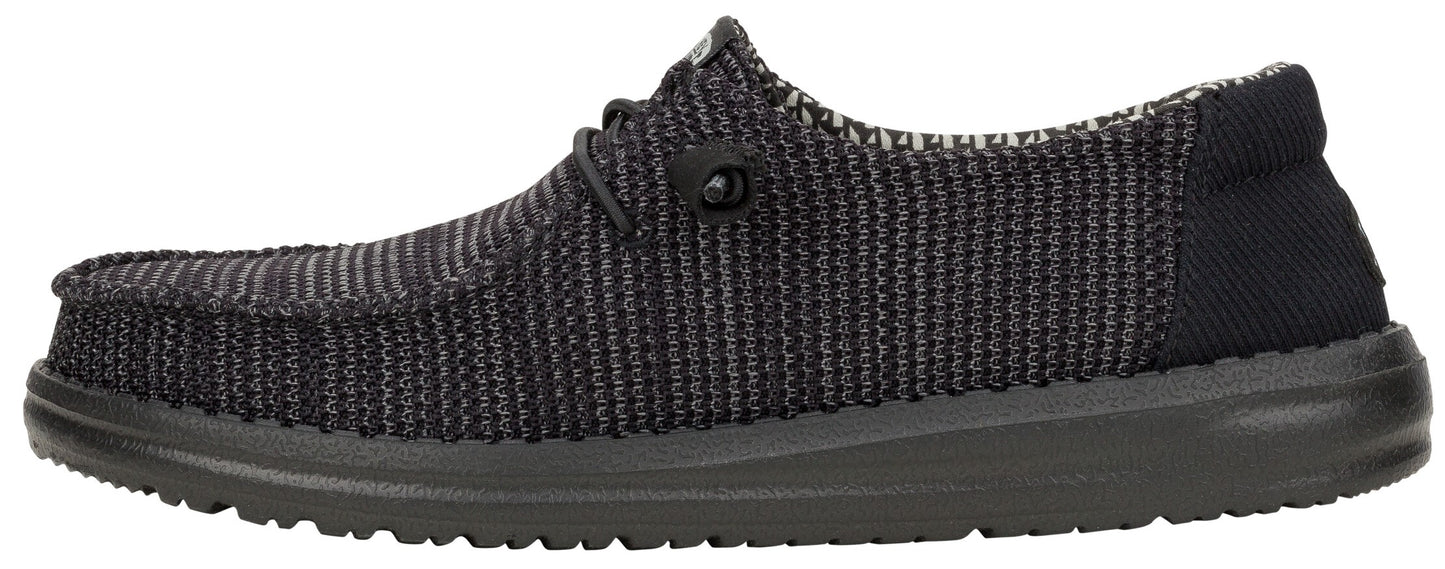 A dark gray woven-fabric slip-on shoe with a low profile and a dark sole.