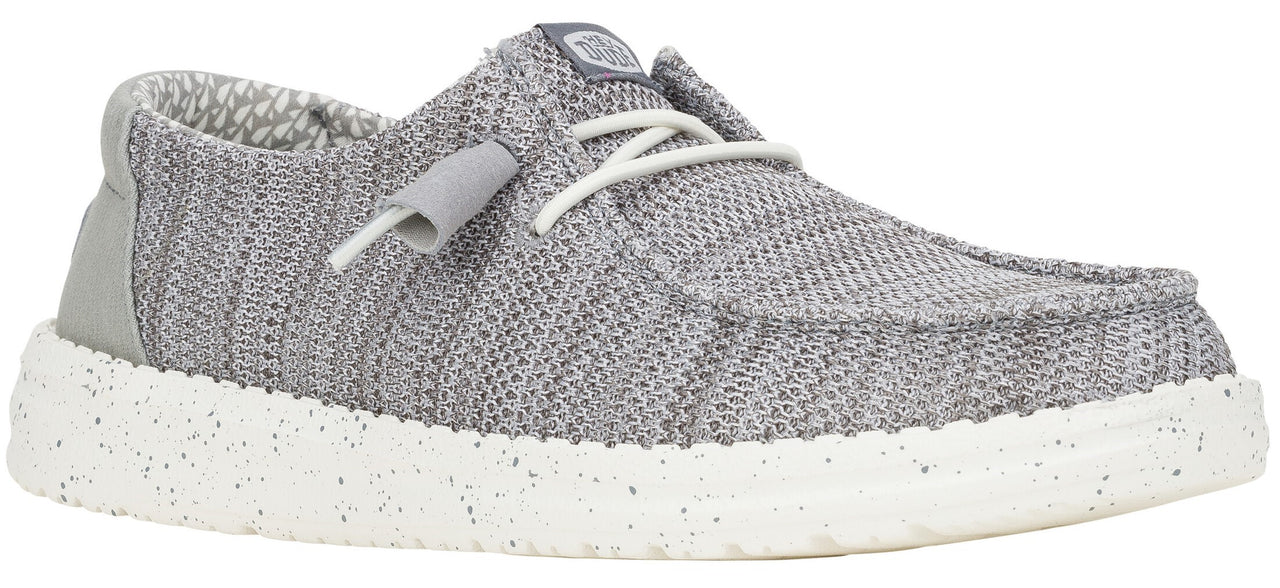 A gray slip-on shoe with white speckled sole and white laces.