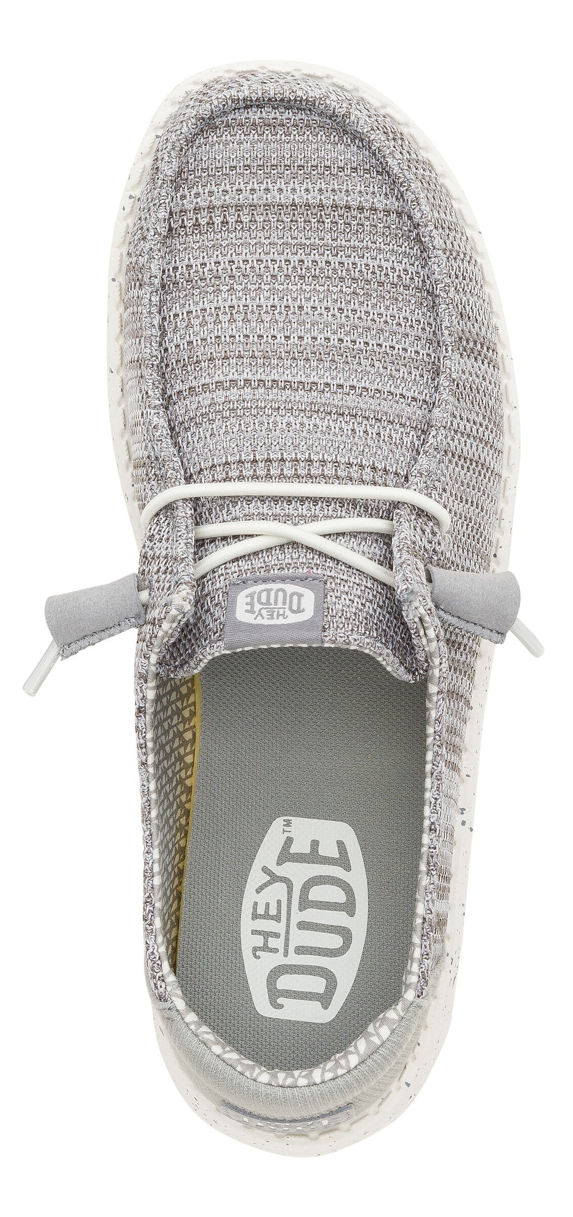 Top-down view of gray slip-on shoes with white laces and visible "HEY DUDE" logo on the inner sole.
