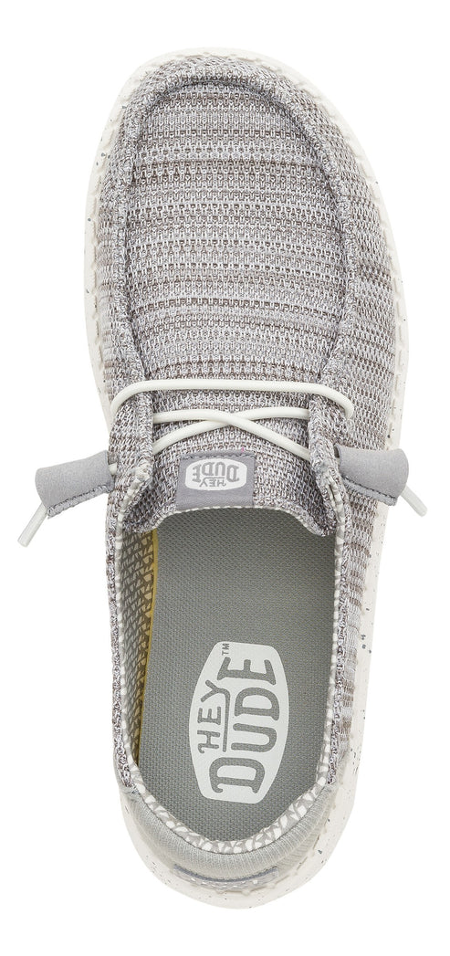 Top-down view of gray slip-on shoes with white laces and visible "HEY DUDE" logo on the inner sole.