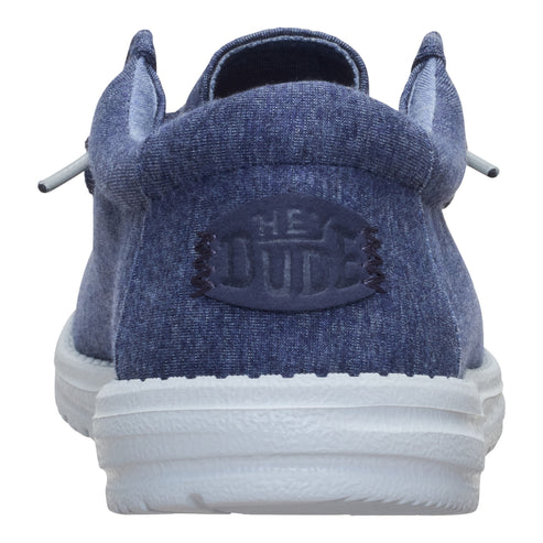 Back view of a blue slip-on shoe with a white sole and a visible logo.