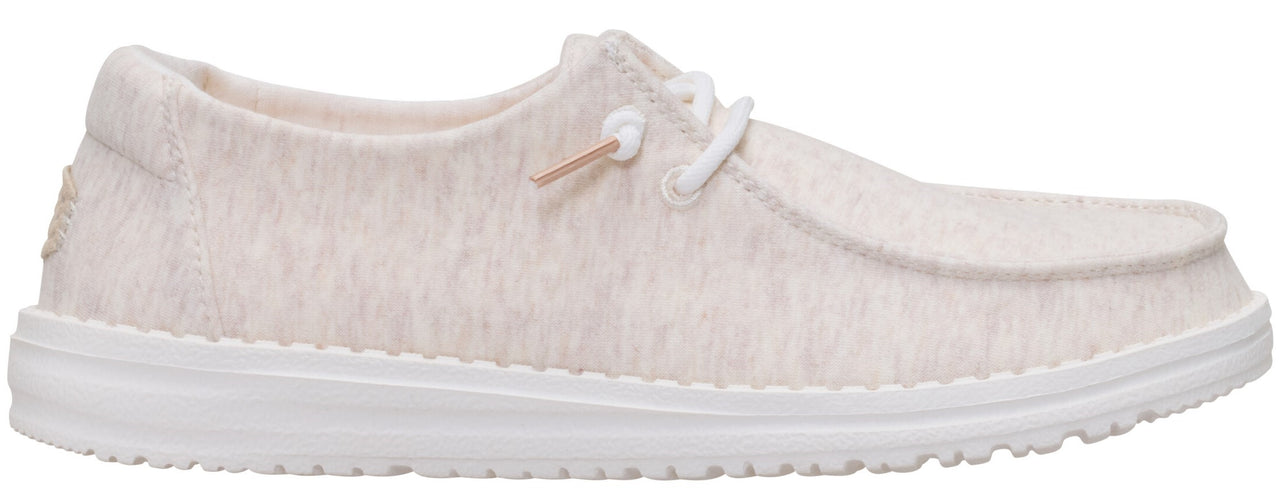 A casual, low-profile shoe with a light-colored, textured upper and white laces.