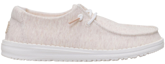A casual, low-profile shoe with a light-colored, textured upper and white laces.