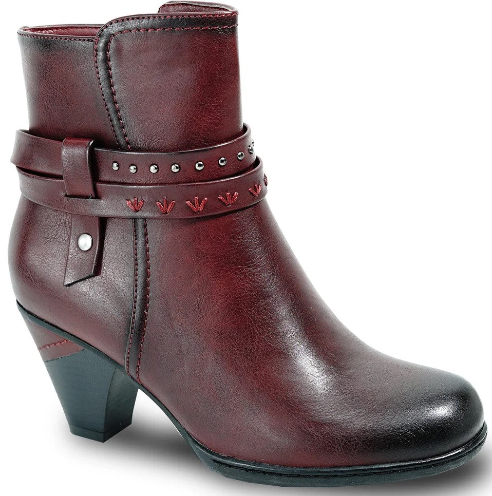 A maroon ankle boot with a block heel, featuring a wrap-around strap adorned with small metallic studs and embroidered floral accents, plus a side button detail and a darker gradient toe.