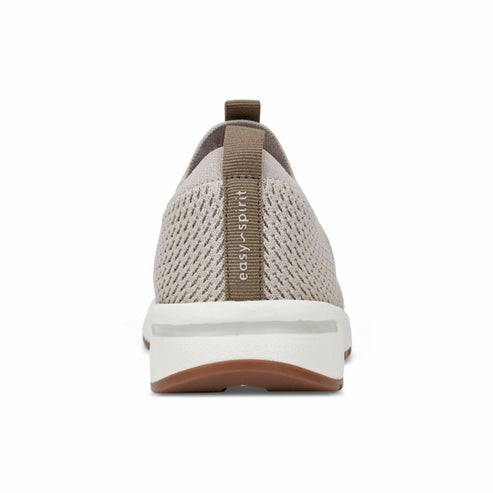 Back of tan-colored slip-on sneaker with white sole and "easy spirit" label on the heel.
