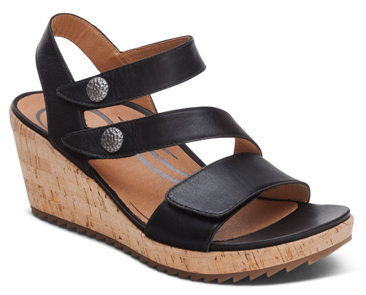 Black wedge sandal with two adjustable straps, silver buttons, and a cork wedge.