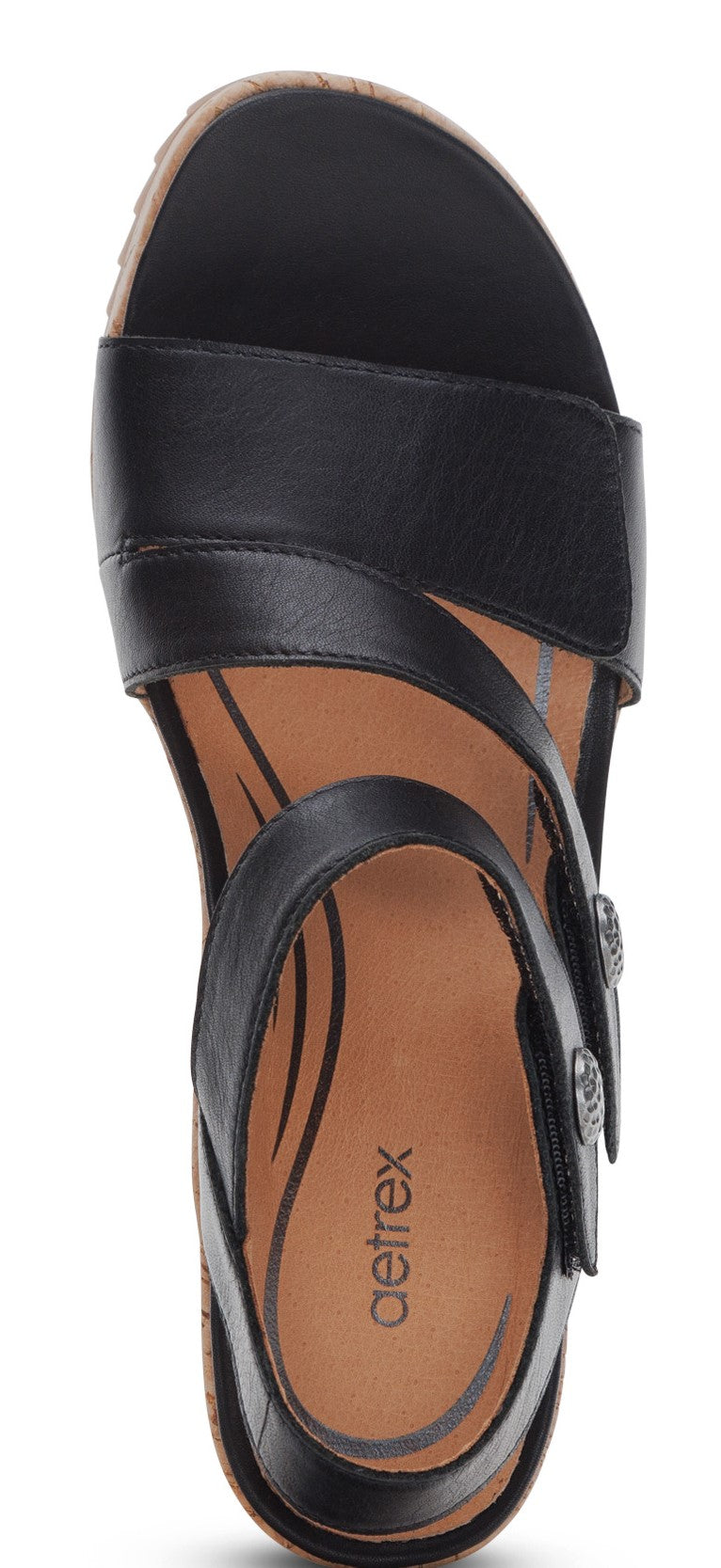 A top-down view of a black sandal with a cork sole and the word "aetrex" printed on the shoe's interior.