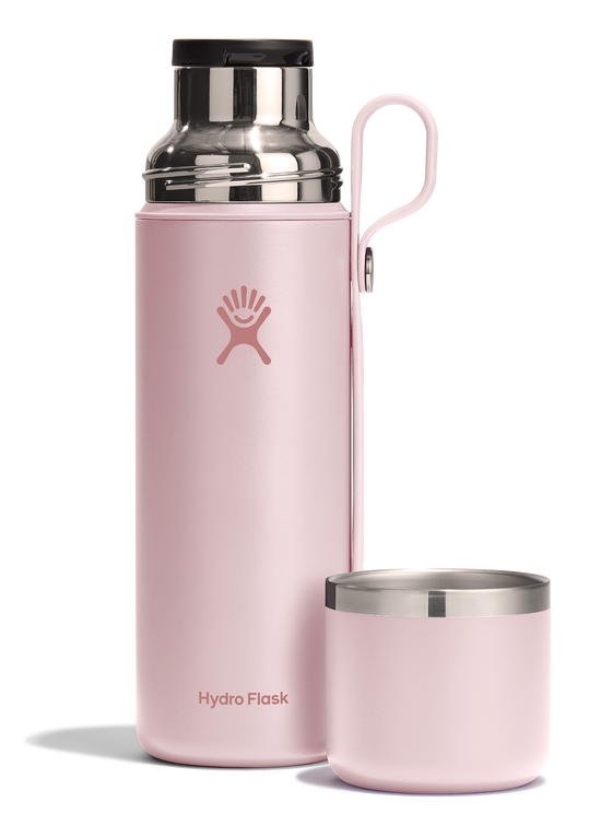 Pink water bottle with handle and removable pink lid.