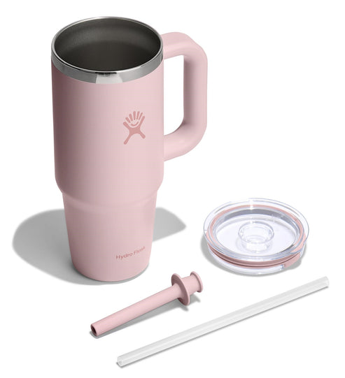 Pink stainless steel mug with handle, lid, straw, and straw cleaner.