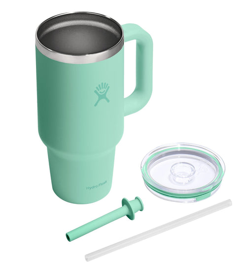 Mint green mug with handle, steel interior, lid, straw, and straw cleaner.