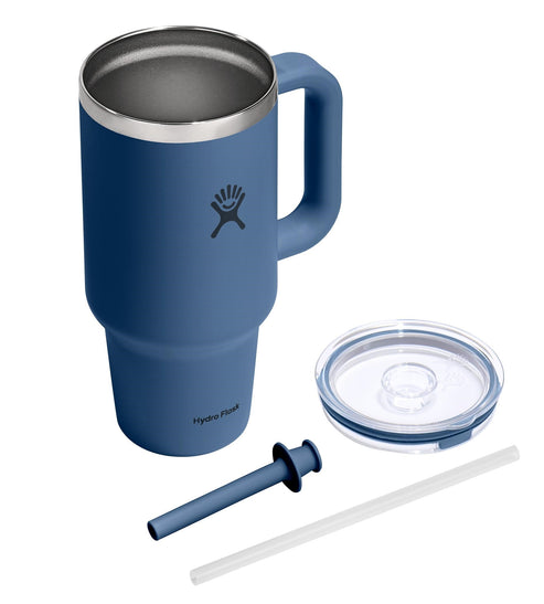 Navy-colored metal mug with handle and a steel-colored rim, plus a straw and a transparent plastic lid.