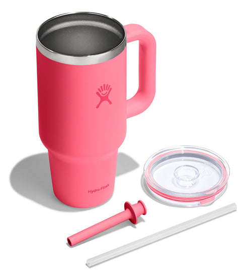 Pink mug with handle, metal interior, a clear lid, a pink straw and a white straw.