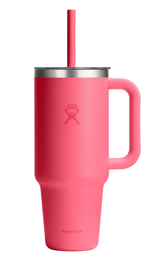 Pink insulated mug with handle and straw.