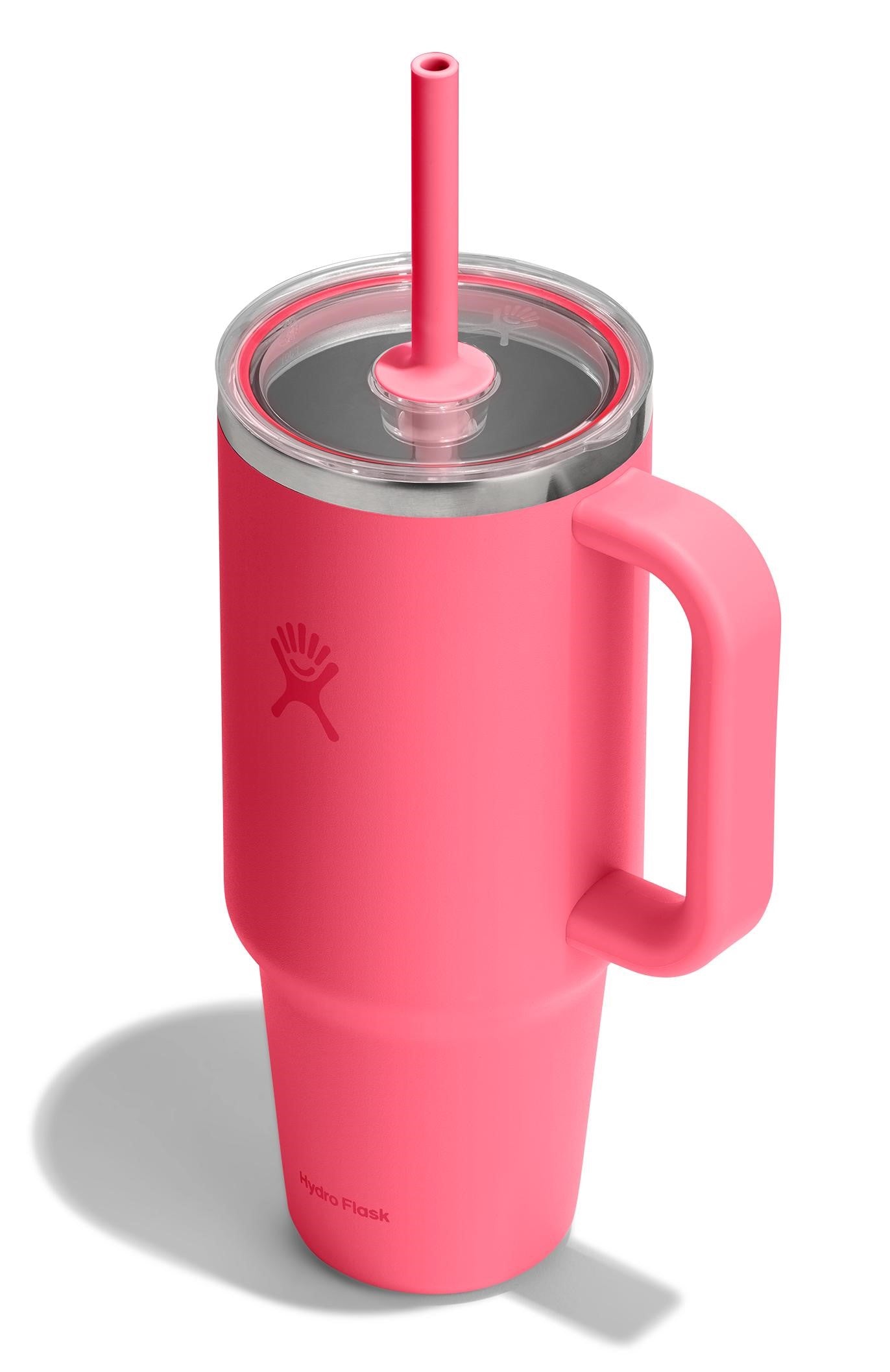 Pink insulated mug with handle and straw.