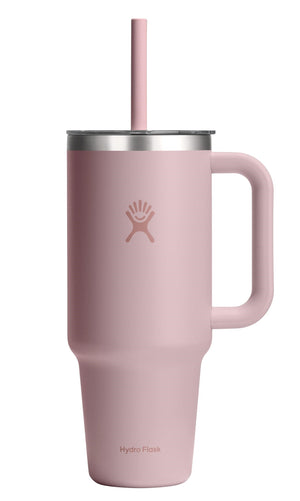 Pink tall mug with a handle and straw.