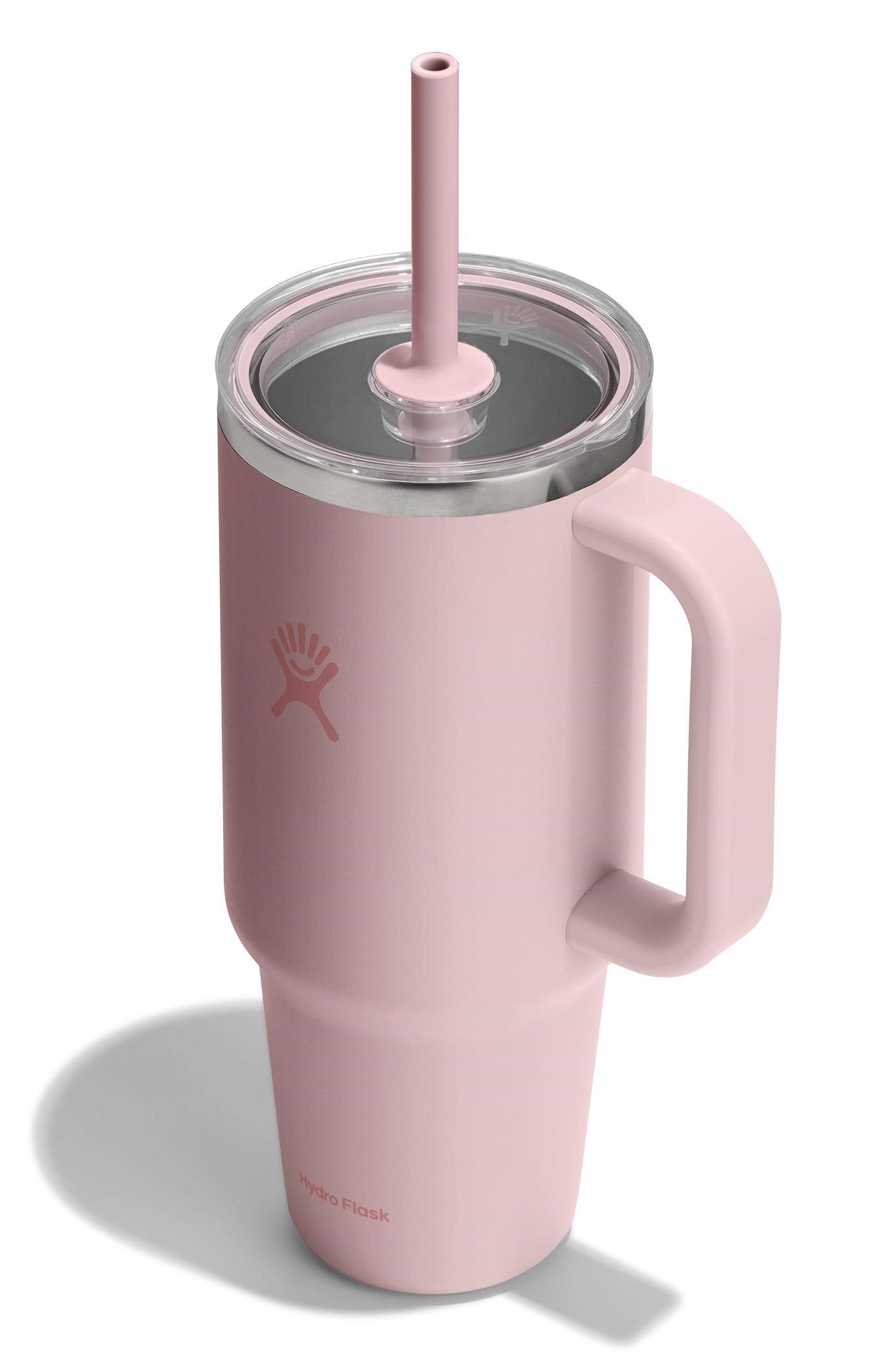 A pink insulated mug with handle, clear lid, and pink straw.