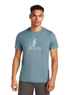 A person wearing a teal tee-shirt with a light gray cartoon polar bear design.