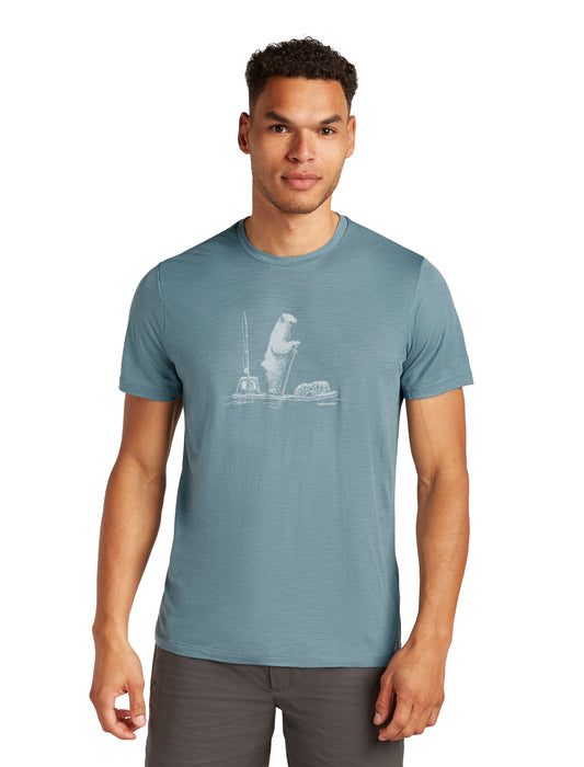 A person wearing a teal tee-shirt with a light gray cartoon polar bear design.