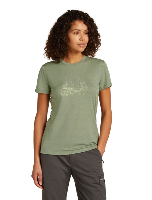 Woman wearing an olive green t-shirt with a mountain graphic, and charcoal pants.