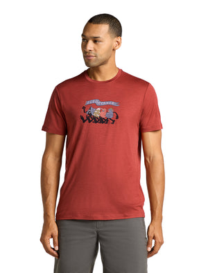 A man wears a red t-shirt with a cartoon image on it.