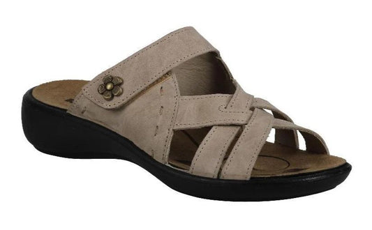 Beige women's slide sandal with criss-cross straps and a flower embellishment on the strap.