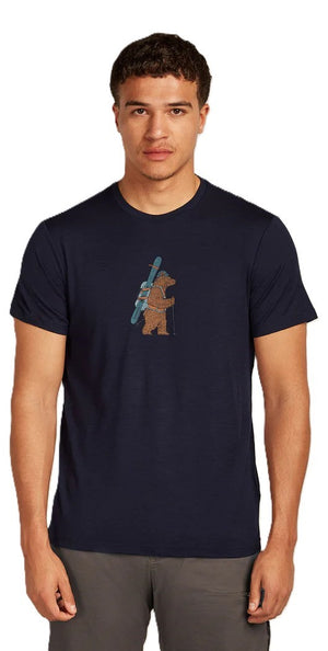 A man wearing a navy shirt with a picture of a bear holding skis.
