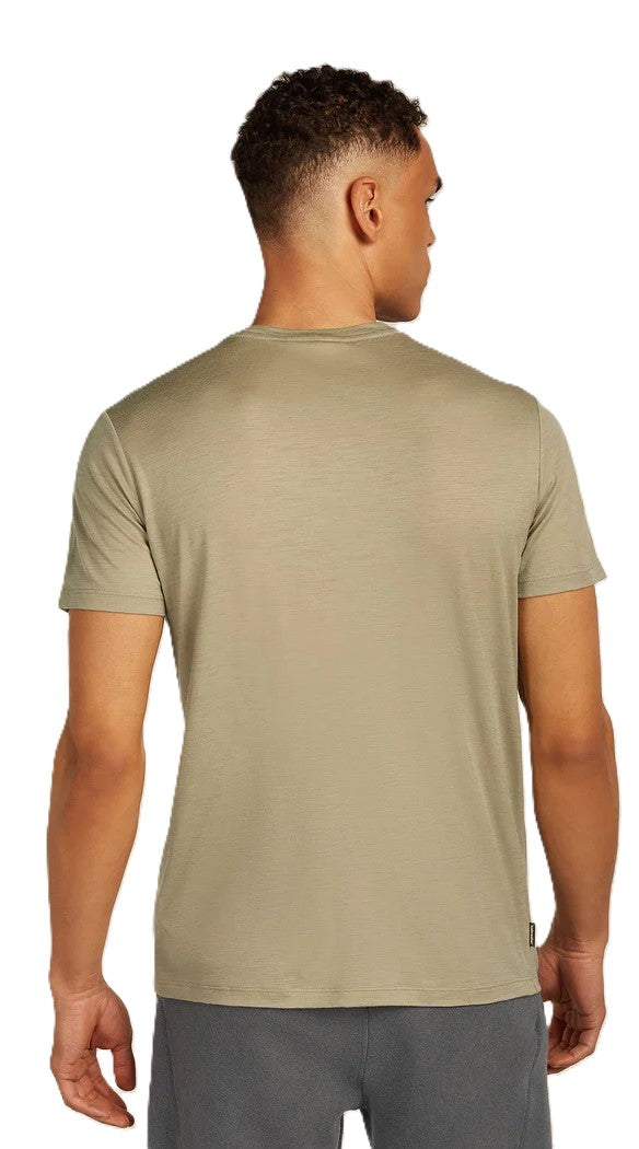 Man wearing a light green tee-shirt, rear view.