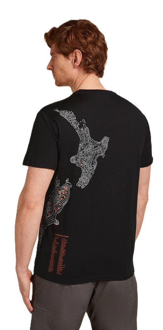 Man wearing a black t-shirt with a white topographic map design and reddish brown text.