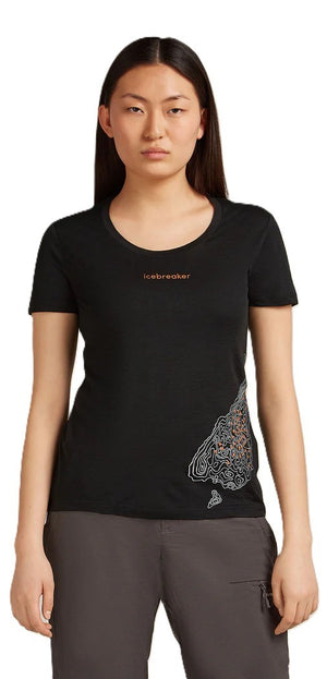 A woman wearing a black short-sleeve shirt with a paisley design on the side.