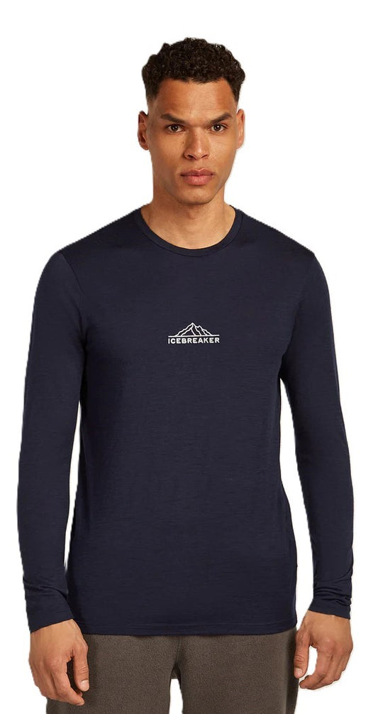 A man wearing a navy long-sleeve shirt with a mountain logo.